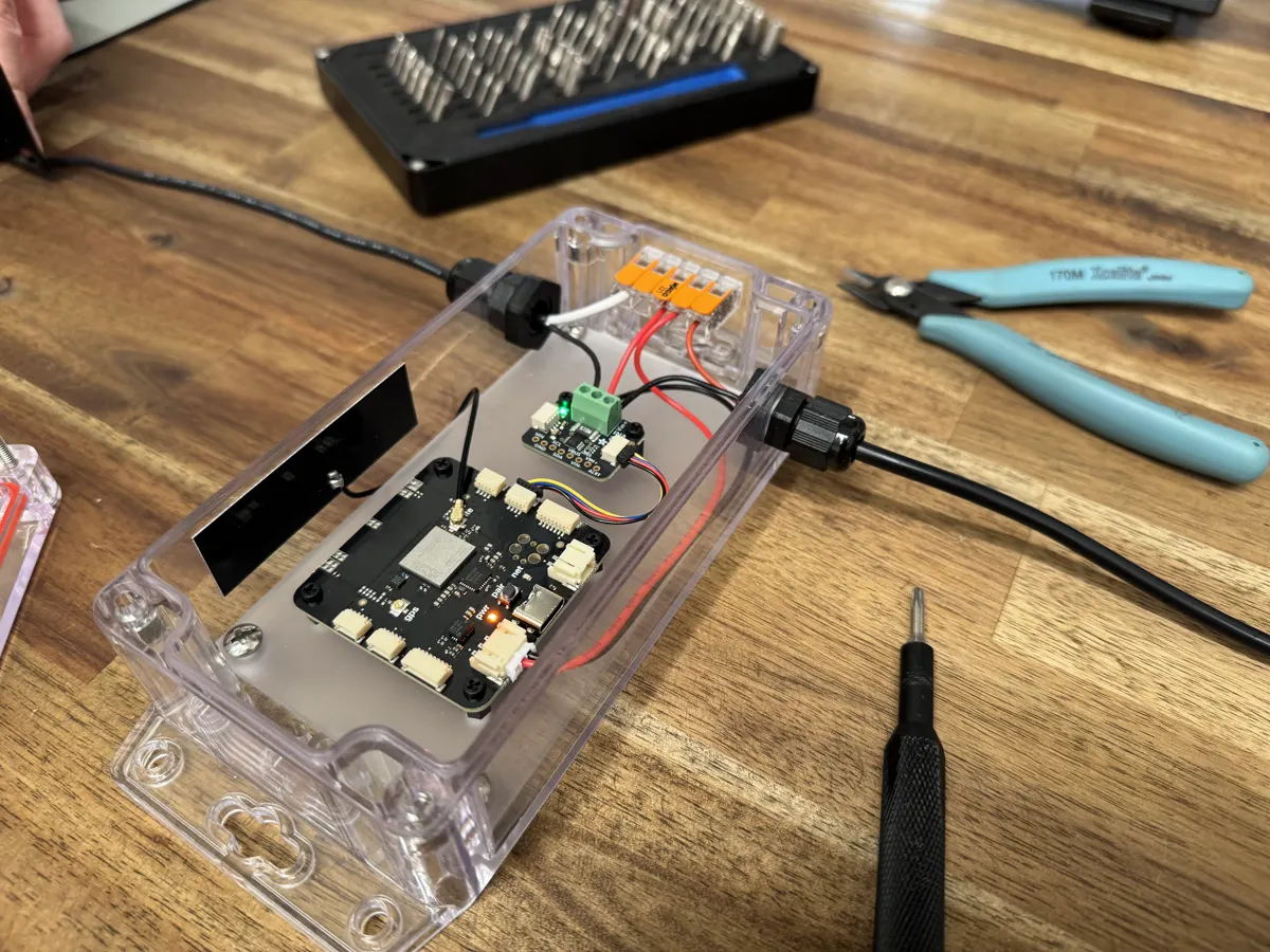 An S2 Module sealed in a clear enclosure on a workbench, with cables through two cable glands